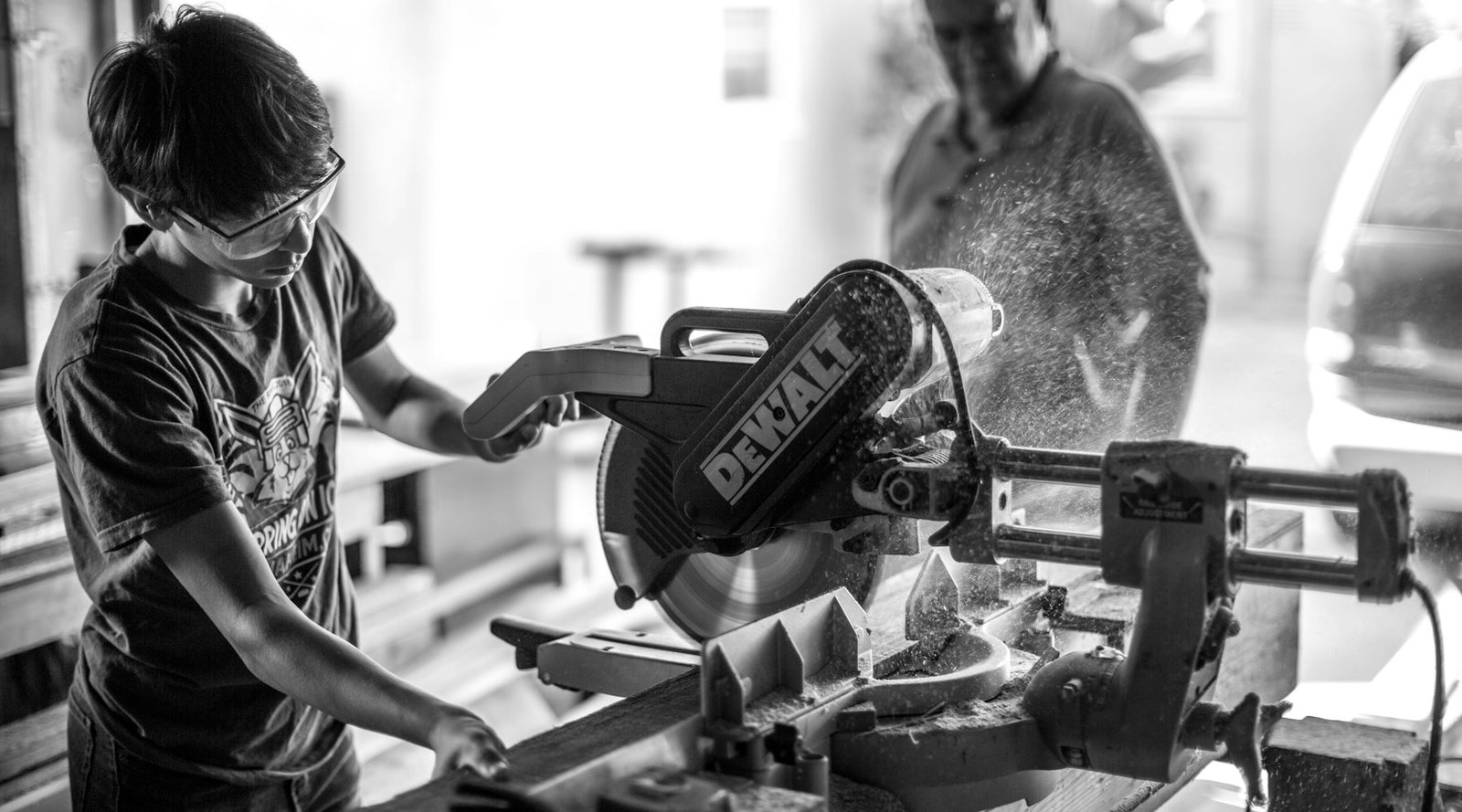A maker using a mitre saw