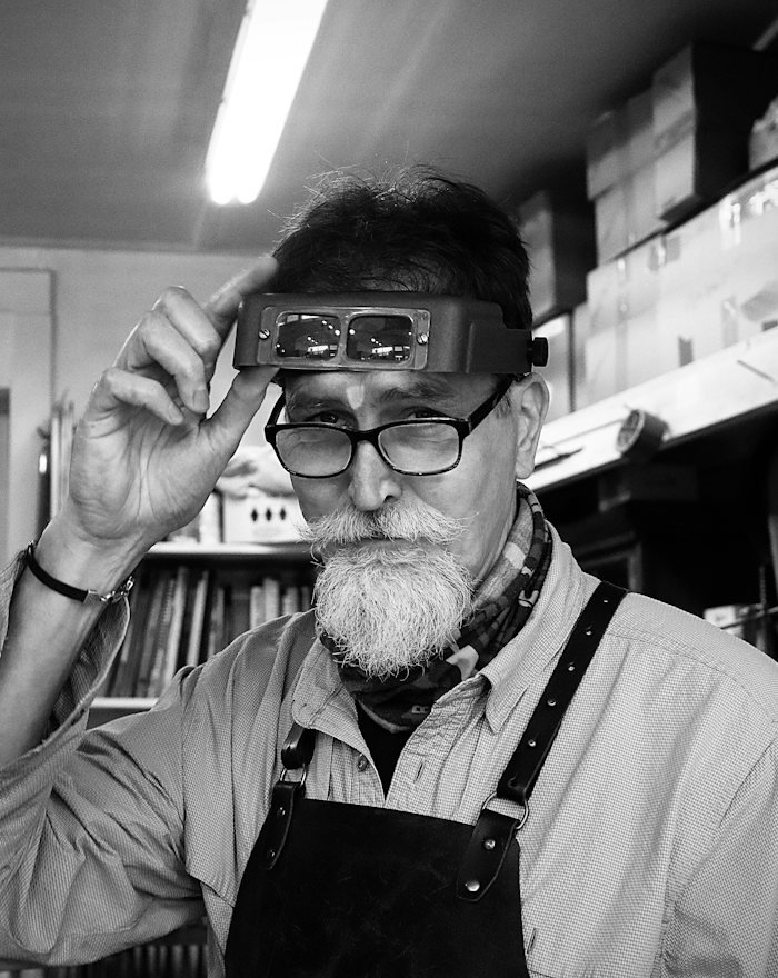A maker wearing a magnifying headband
