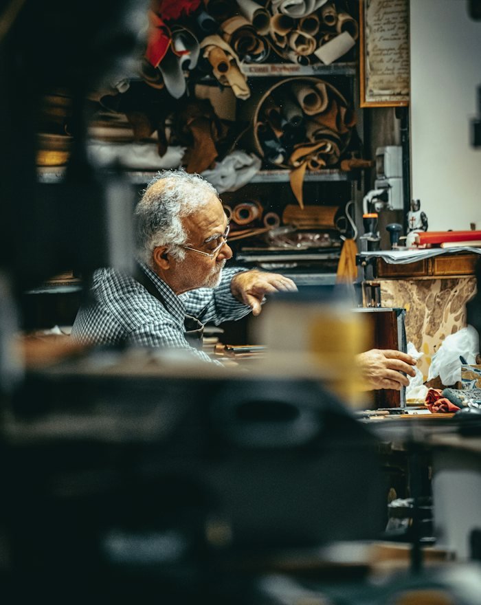 A maker seated in the workshop