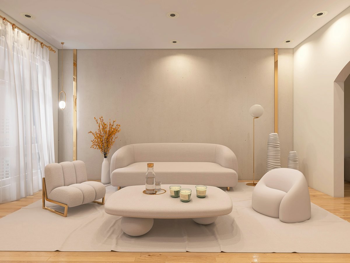 A living room with a white sofa and chairs
