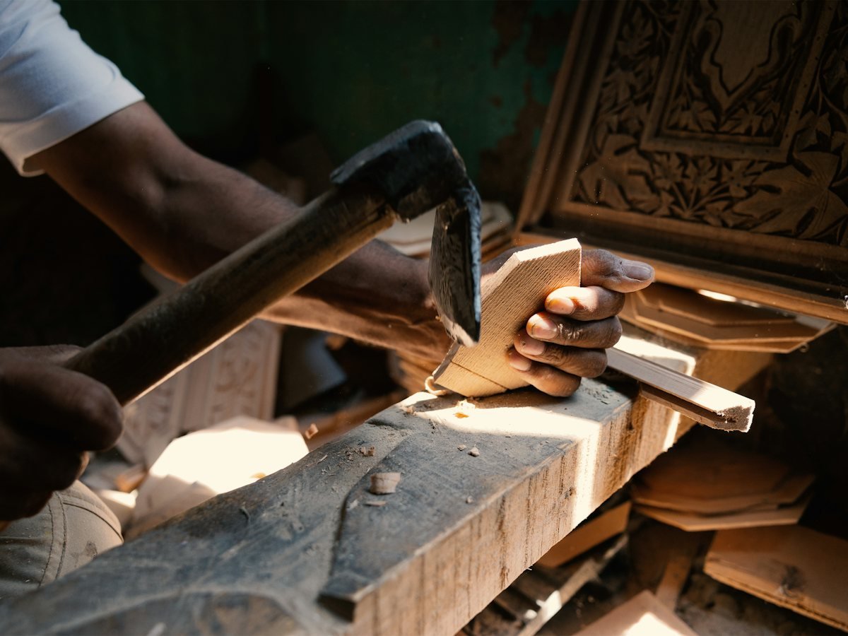 A craftsman working timber at a bench