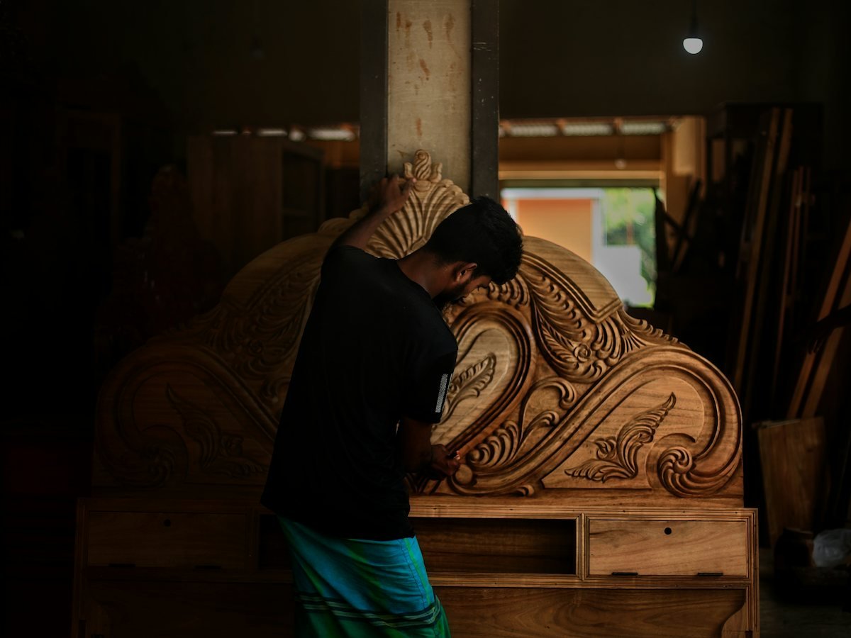 A maker beside a large finished piece